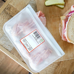 Set of four reusable half-gallon food storage bags with sliced deli meat—lightweight for bringing to the deli counter and airtight for keeping meats fresh and organized in the fridge.