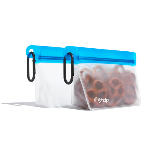 Cobalt (re)zip Take Me Too stand-up 1‑cup reusable snack bag with carabiner, filled with trail mix and fruit slices – perfect for on‑the‑go, hiking, and travel snack organization
