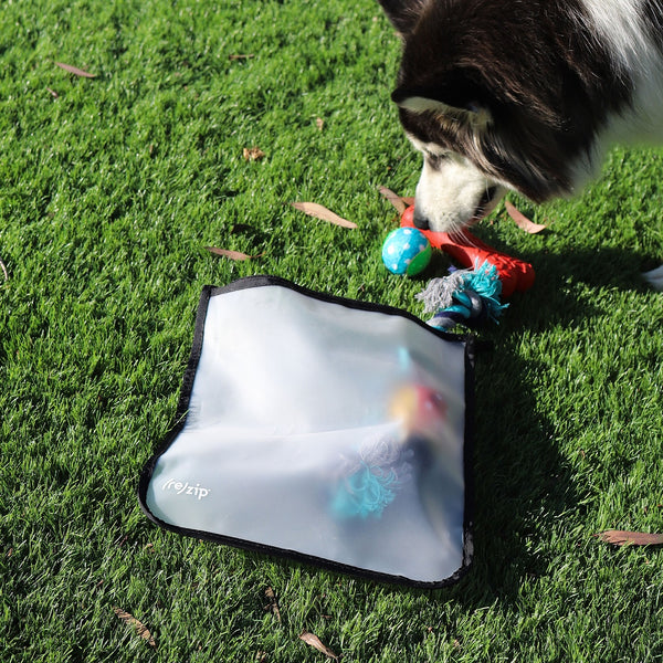 Zippered gallon-sized reusable bag filled with dog toys—durable, food-grade PEVA storage for organizing pet toys at home or for the dog park and travel.